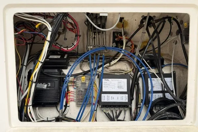 Slide: The Image of Electrical wiring and components inside a 2009 Spectre 37 boat compartment. - 28