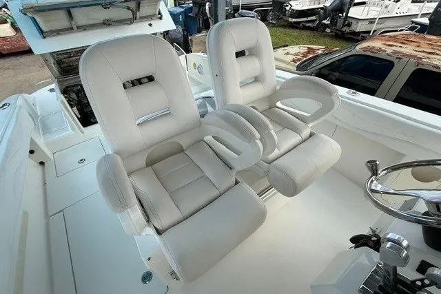 Slide: The Image of Luxury seating on a 2009 Spectre 37 boat, featuring plush white captain chairs. - 14