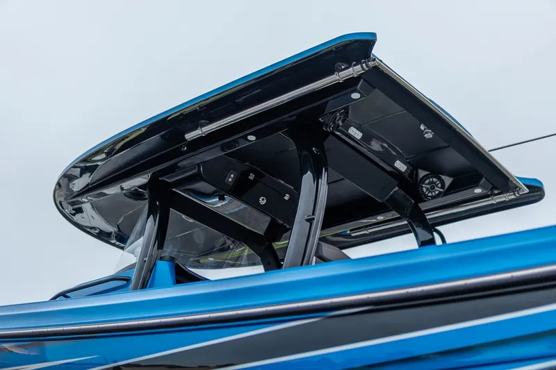 Slide: The Image of 2022 Fountain 39 NX boat with sleek blue and black design, featuring a sturdy T-top. - 31