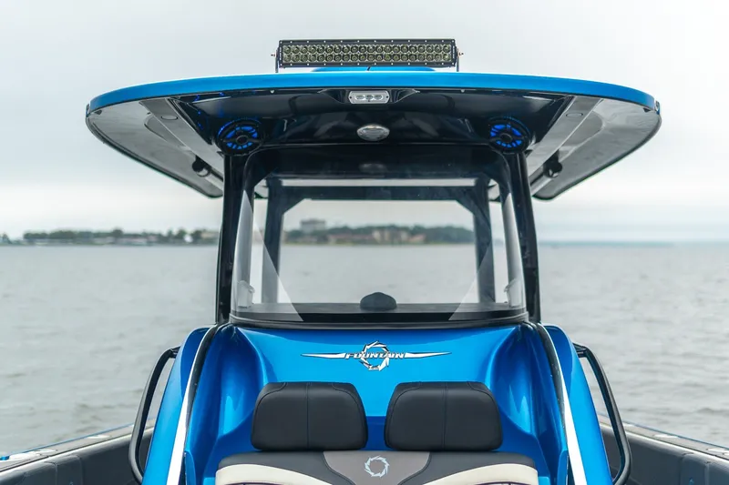 Slide: The Image of 2022 Fountain 39 NX boat with sleek blue design on open water. - 29