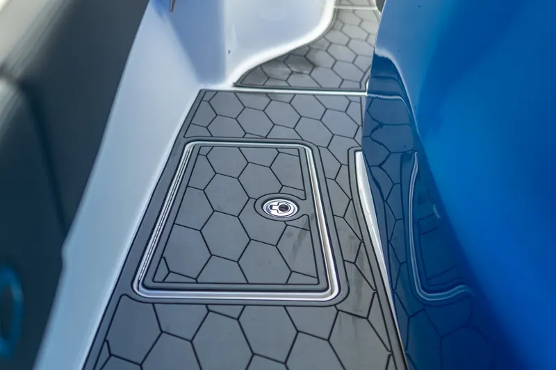 Slide: The Image of 2022 Fountain 39 NX boat deck with hexagonal pattern and storage hatch. - 22