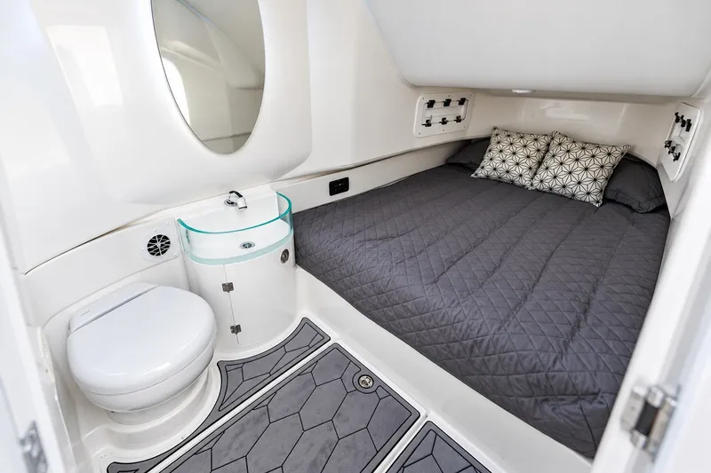 Slide: The Image of 2022 Fountain 39 NX cabin interior with bed, toilet, and sink. - 32