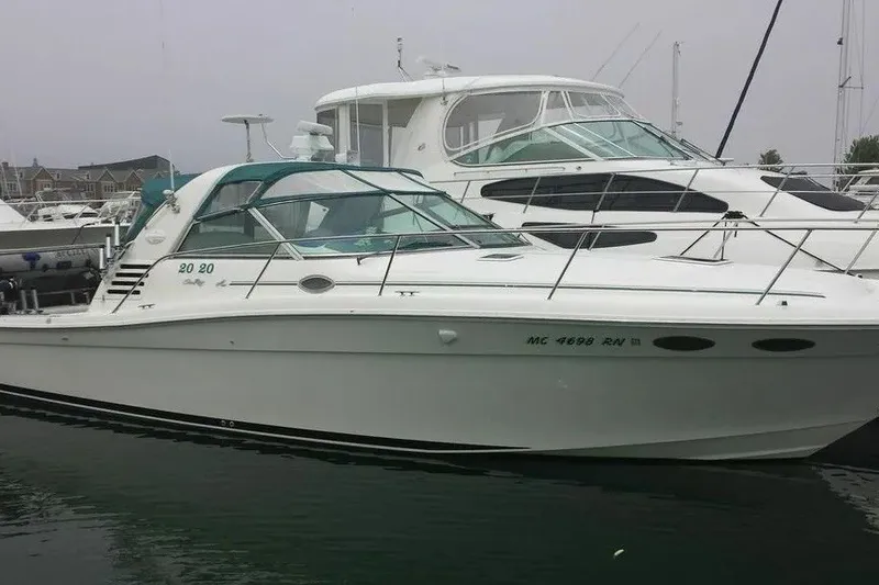 Slide: The Image of 1998 Sea Ray 370 Express Cruiser docked in marina, side view. - 5