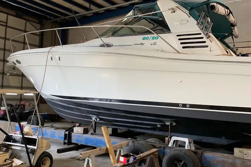 Slide: The Image of 1998 Sea Ray 370 Express Cruiser in a garage, side view. - 10