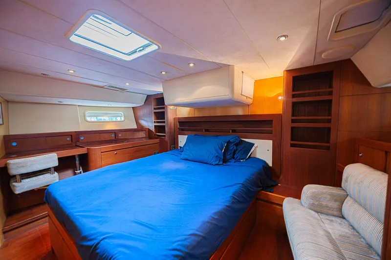 Slide: The Image of Luxurious cabin interior of 2007 CNB 70 yacht with blue bedding and wooden furnishings. - 50