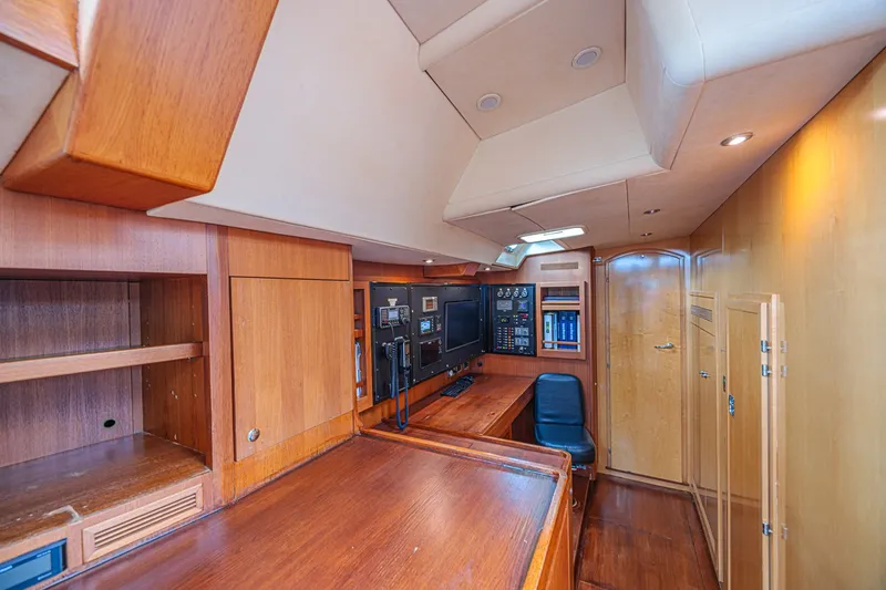 Slide: The Image of Luxurious interior of a 2007 CNB 70 yacht featuring a navigation station and wooden cabinetry. - 45
