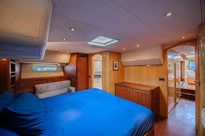 Slide: The Image of Luxurious cabin interior of 2007 CNB 70 yacht with blue bedding and wooden furnishings. - 49
