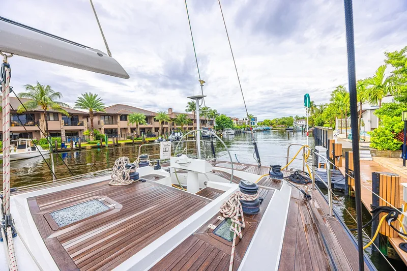 Slide: The Image of Sailing yacht CNB 70 (2007) docked in a scenic waterfront neighborhood. - 33