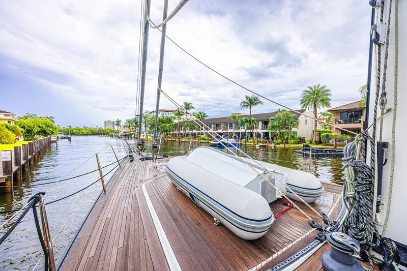 Slide: The Image of Deck view of a 2007 CNB 70 yacht docked by waterfront homes. - 20