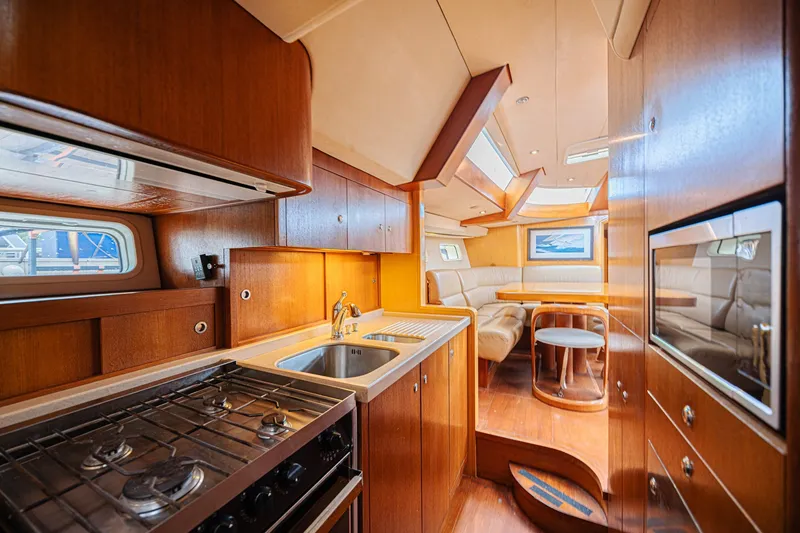 Slide: The Image of Luxurious interior of a 2007 CNB 70 yacht featuring a modern kitchen and cozy seating area. - 47