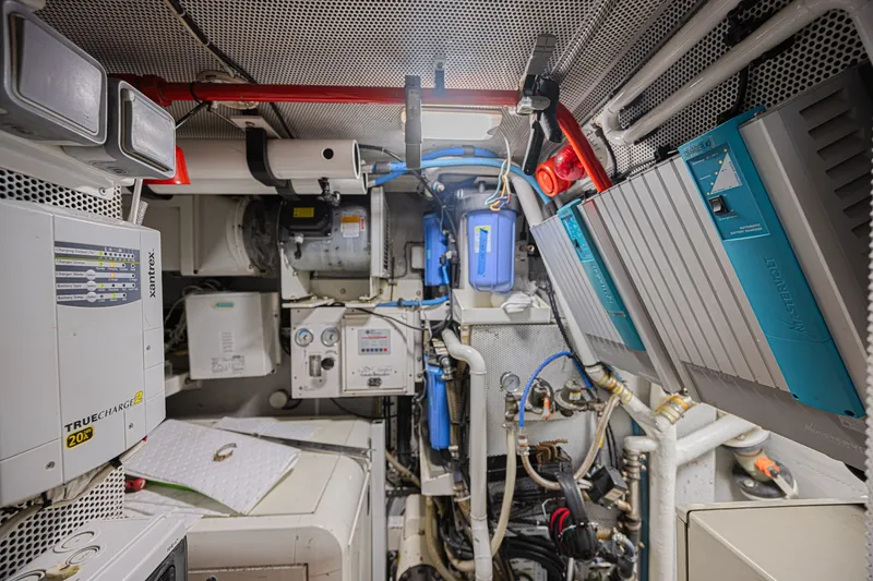 Slide: The Image of Engine room of a 2007 CNB 70 yacht, featuring electrical and mechanical systems. - 62