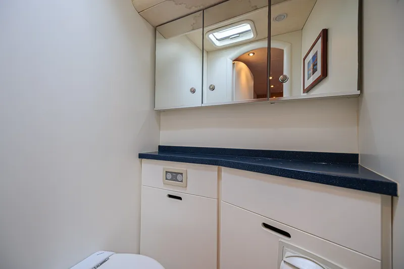 Slide: The Image of Luxurious bathroom interior on a 2007 CNB 70 yacht, featuring sleek cabinetry and mirrors. - 52