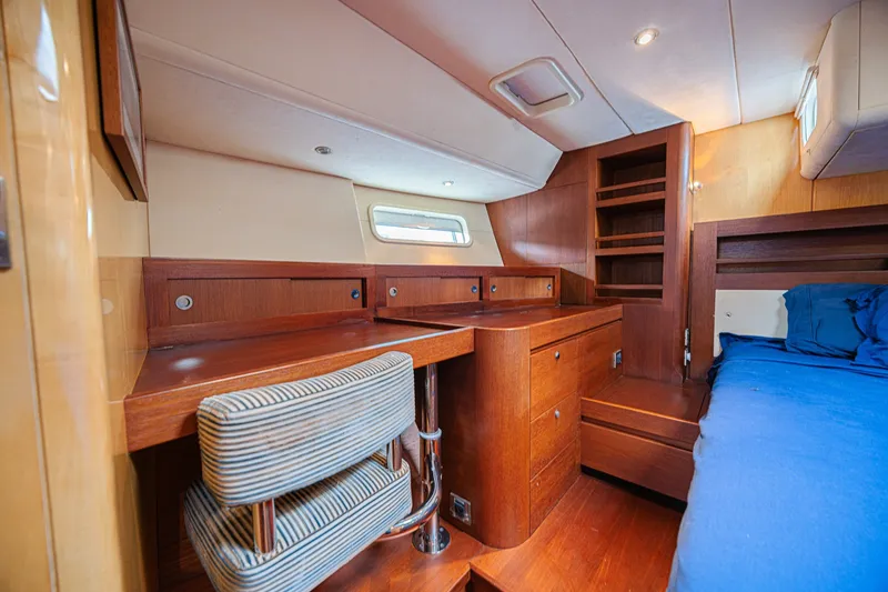Slide: The Image of Luxurious cabin interior of a 2007 CNB 70 yacht with wooden furnishings and a cozy bed. - 51