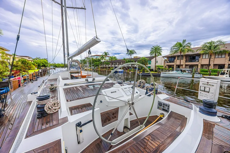 Slide: The Image of Sailing yacht CNB 70, 2007 model, docked in a scenic marina with palm trees. - 30
