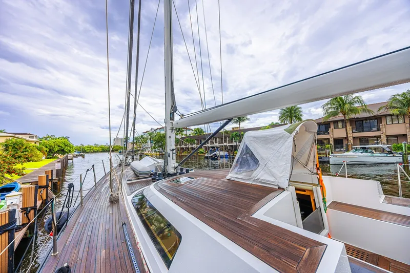 Slide: The Image of Luxurious 2007 CNB 70 yacht docked by waterfront homes under cloudy skies. - 15