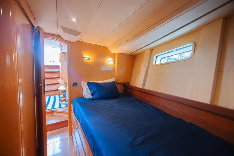 Slide: The Image of Luxurious cabin interior of 2007 CNB 70 yacht with cozy bed and wooden accents. - 54