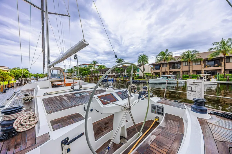 Slide: The Image of Luxurious 2007 CNB 70 yacht docked by waterfront homes under cloudy skies. - 23