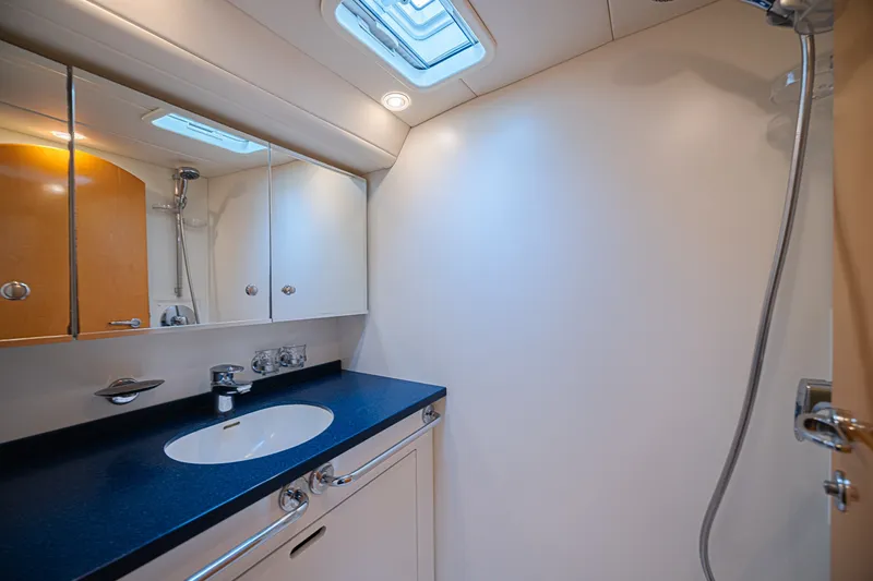 Slide: The Image of Luxurious yacht bathroom with sleek design, featuring a modern sink and mirrored cabinets. CNB 70, 2007. - 53