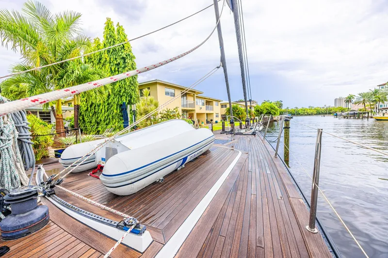 Slide: The Image of Luxurious CNB 70 yacht deck with inflatable boat, docked near waterfront homes, 2007 model. - 31