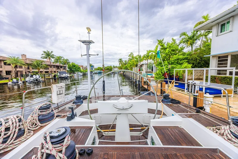 Slide: The Image of Luxury CNB 70 yacht docked in a scenic canal, surrounded by lush greenery. - 28