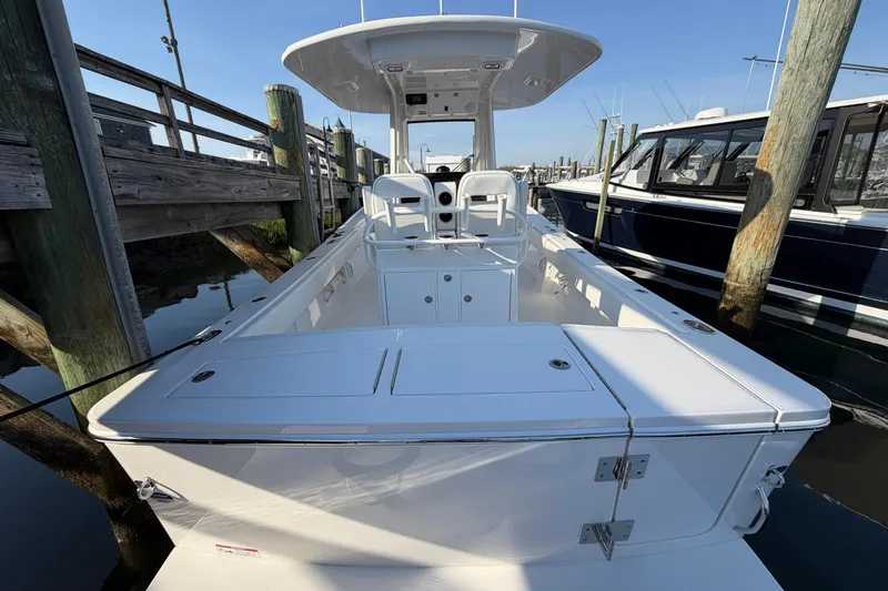 Slide: The Image of 2026 Regulator 28 boat docked, showcasing spacious deck and seating area. - 19
