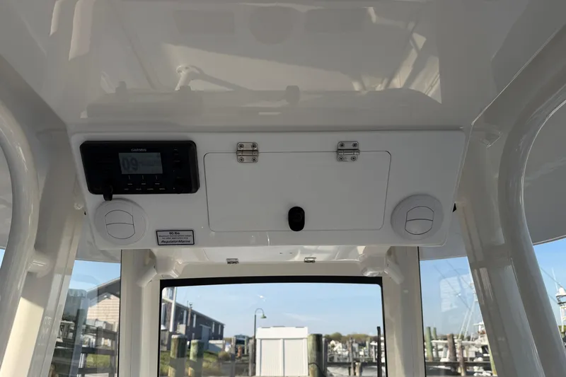Slide: The Image of 2026 Regulator 28 boat interior with Garmin device and storage compartment. - 36