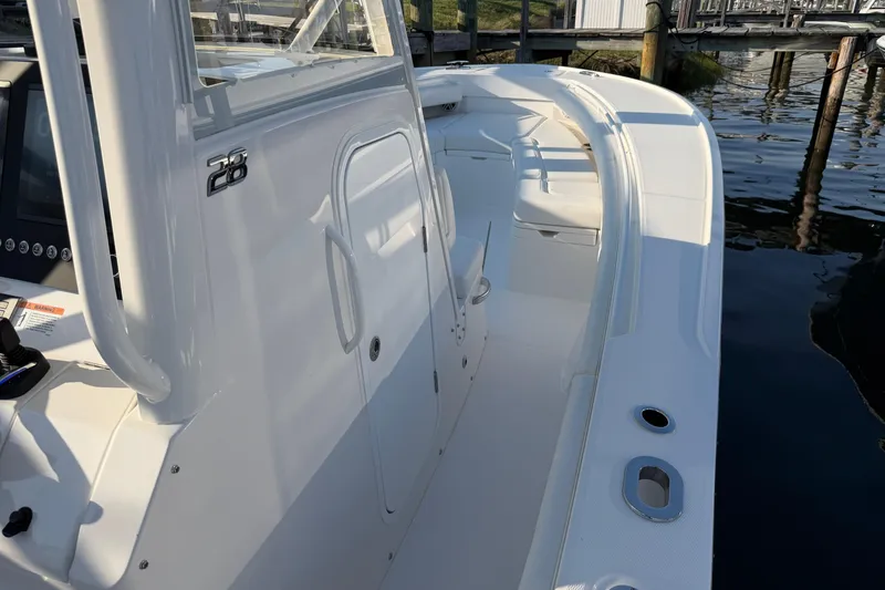 Slide: The Image of 2026 Regulator 28 boat interior, showcasing sleek design and spacious seating near the dock. - 50