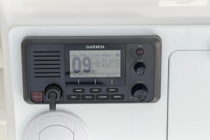 Slide: The Image of Garmin marine radio on 2026 Regulator 28 boat dashboard, displaying channel and coordinates. - 37