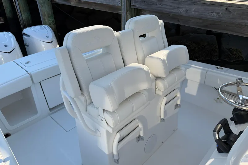 Slide: The Image of 2026 Regulator 28 boat with dual white captain's chairs and Yamaha engines. - 46