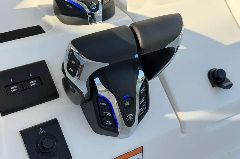 Slide: The Image of Throttle controls on a 2026 Regulator 28 boat dashboard, featuring Yamaha branding. - 44