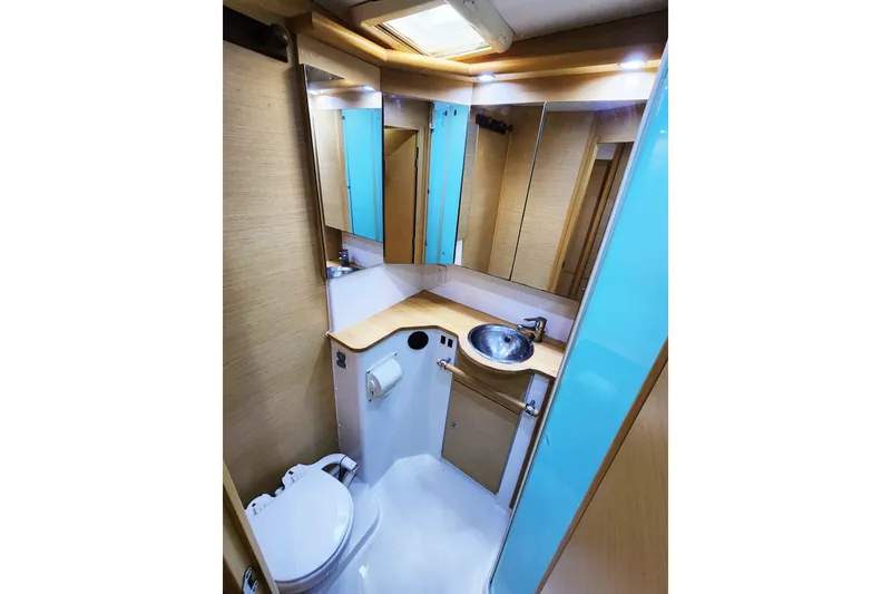 Slide: The Image of Compact bathroom in a 2008 Lagoon 500 yacht, featuring modern fixtures and ample storage. - 57