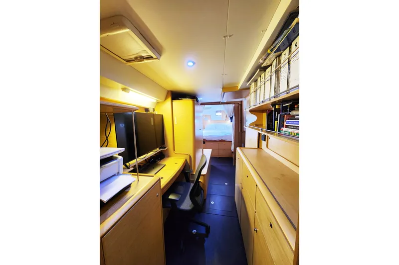 Slide: The Image of Office space inside a 2008 Lagoon 500 yacht with desk, chair, and shelves. - 47