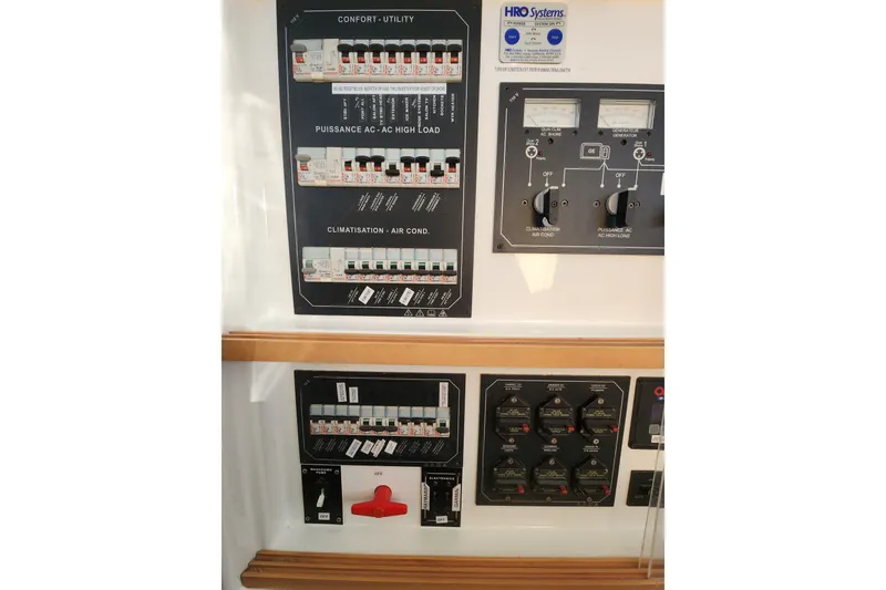 Slide: The Image of Electrical control panel on a 2008 Lagoon 500 yacht, featuring switches and meters. - 40