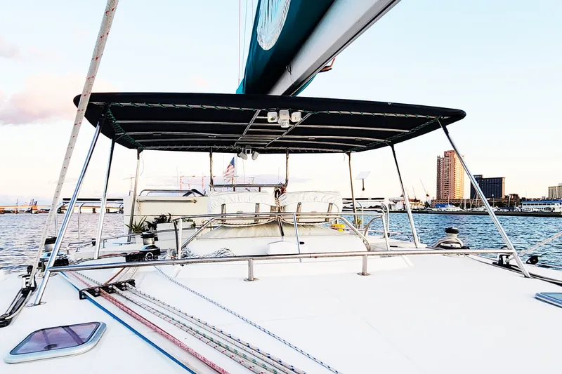 Slide: The Image of 2008 Lagoon 500 yacht with canopy, docked in a marina at sunset. - 13