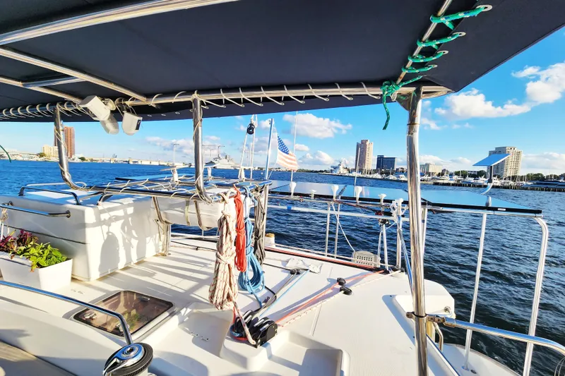Slide: The Image of Lagoon 500 catamaran from 2008, docked with city skyline and blue sky in the background. - 15