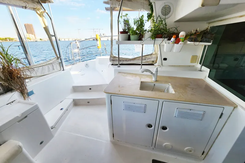 Slide: The Image of Outdoor kitchen on a 2008 Lagoon 500 catamaran with sink and potted plants. - 31