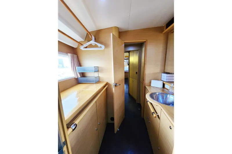 Slide: The Image of Interior of 2008 Lagoon 500 yacht with wooden cabinetry and compact sink. - 51