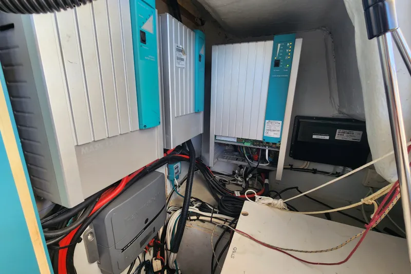 Slide: The Image of Electrical system inside a 2008 Lagoon 500 yacht, featuring wiring and control panels. - 62
