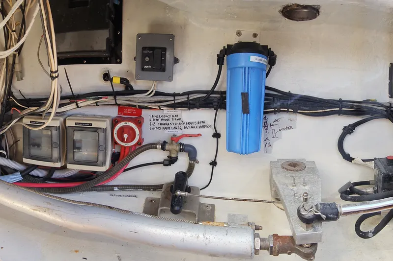 Slide: The Image of Electrical and plumbing system inside a 2008 Lagoon 500 yacht, featuring wiring and a blue filter. - 68