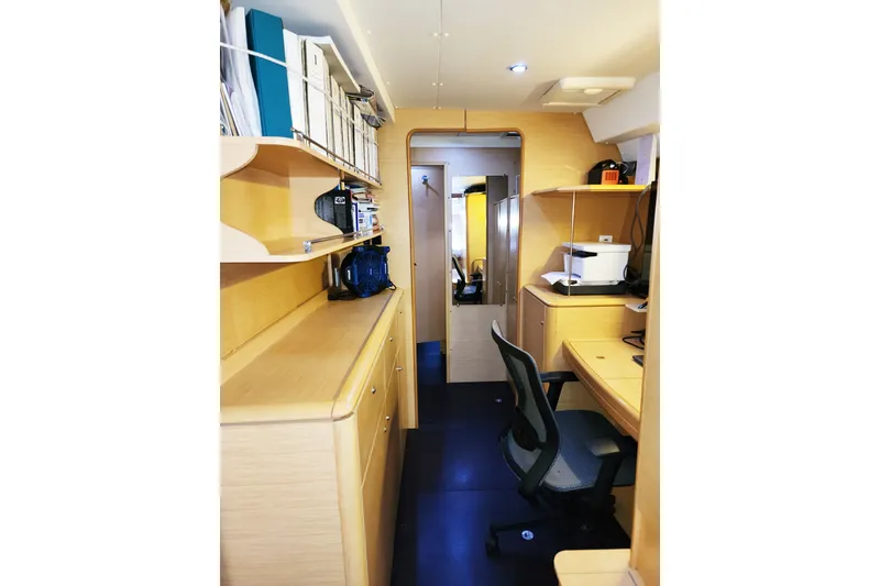 Slide: The Image of Interior of 2008 Lagoon 500 yacht with office setup, shelves, and desk. - 46