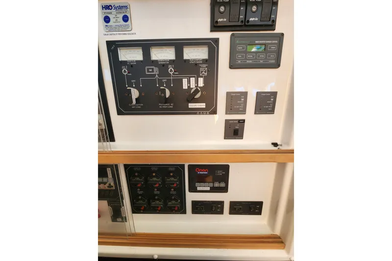 Slide: The Image of Electrical control panel of a 2008 Lagoon 500 yacht, featuring various switches and gauges. - 41