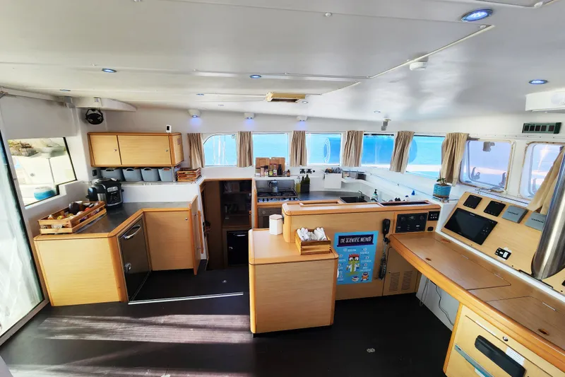 Slide: The Image of Spacious interior of a 2008 Lagoon 500 catamaran with modern kitchen and navigation area. - 33