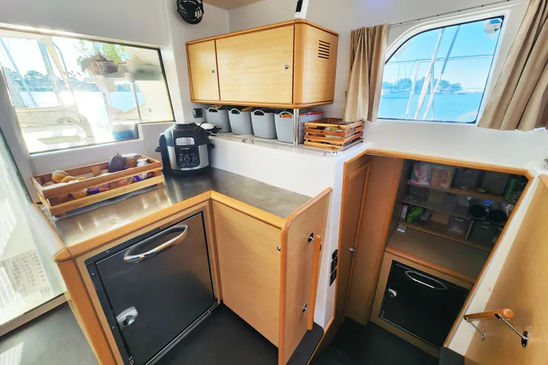 Slide: The Image of Modern kitchen interior of 2008 Lagoon 500 yacht with wooden cabinets and appliances. - 34