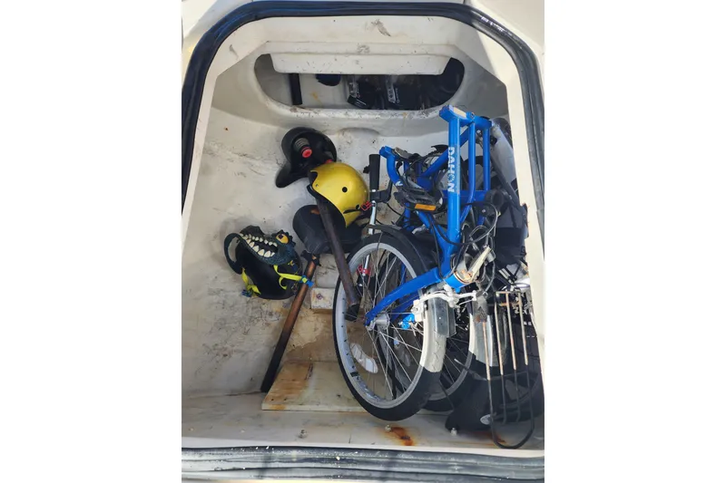 Slide: The Image of Storage compartment of a 2008 Lagoon 500 with a folded bike and gear. - 70