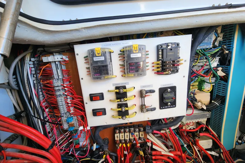 Slide: The Image of Electrical panel of a 2008 Lagoon 500 yacht with wiring and circuit breakers. - 63