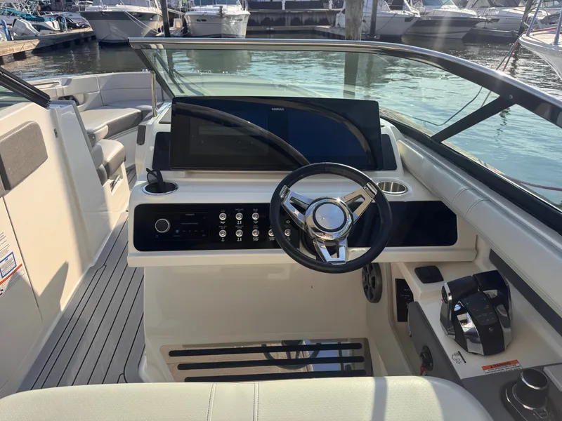 Slide: The Image of The image shows the cockpit of a 2020 Sea Ray SLX 310 Outboard with a modern helm. - 16