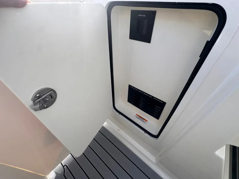 Slide: The Image of An open door with a control panel on a 2020 Sea Ray SLX 310 Outboard. - 20