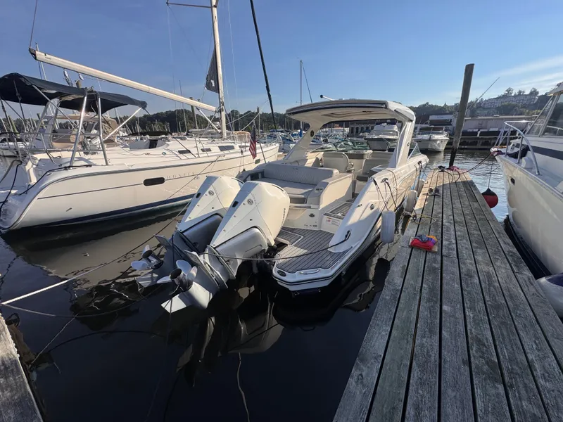 Slide: The Image of A 2020 Sea Ray SLX 310 Outboard docked at a wooden pier in a marina. - 5