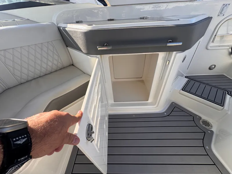 Slide: The Image of An open storage compartment on a 2020 Sea Ray SLX 310 Outboard boat. - 22
