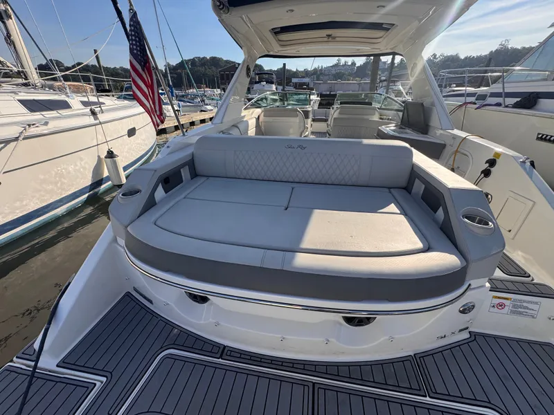 Slide: The Image of The image shows the stern of a Sea Ray SLX 310 Outboard with gray cushions and cup holders. - 9